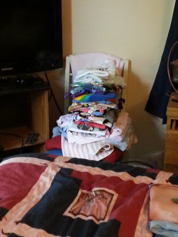 Pile of t-shirts on a chair