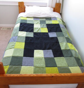 Photo of an afghan made to look like a Creeper from Minecraft.