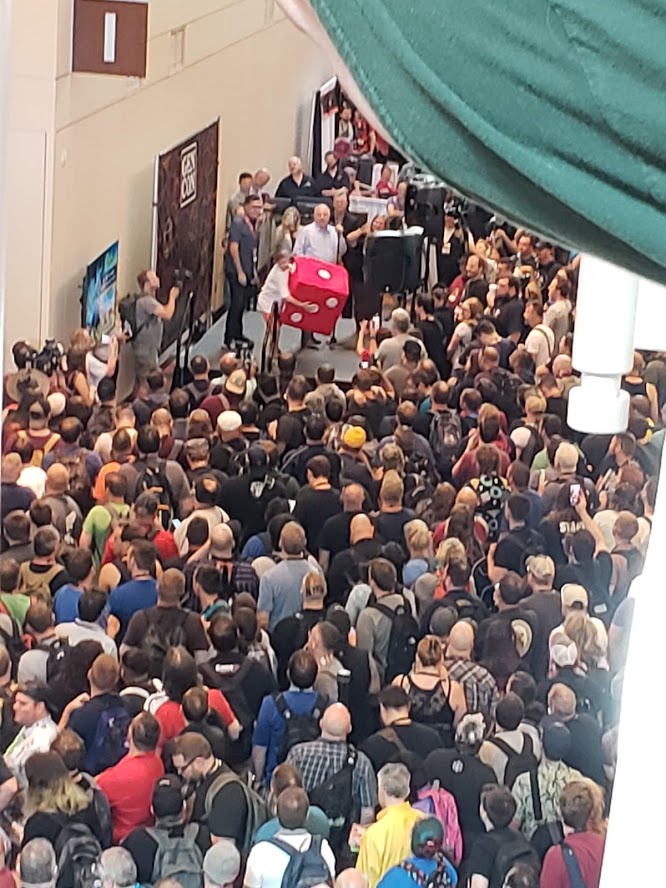 Drake Kiderlen making the first dice roll of Gen Con on Thursday morning.